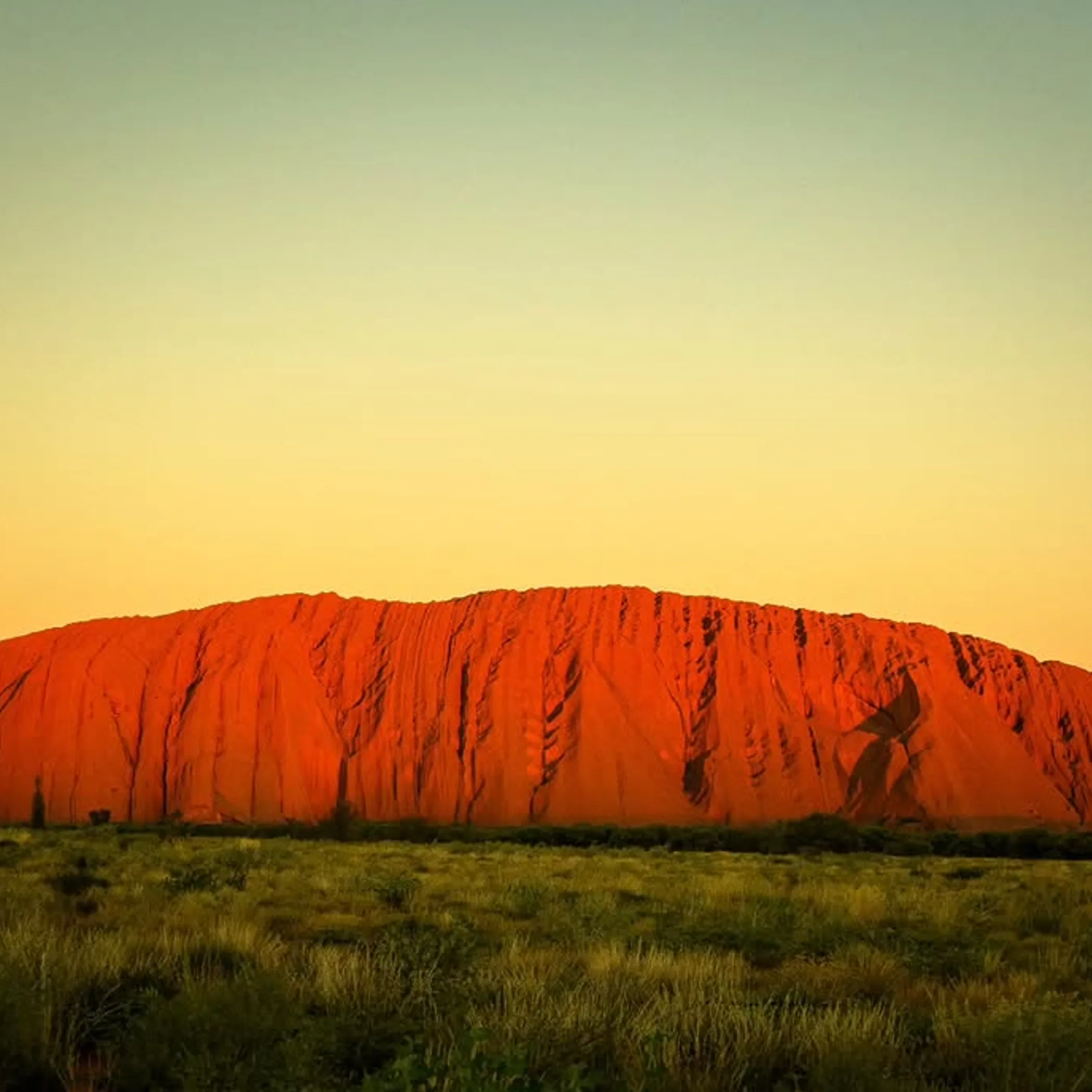 uluru rock formation under clear sky